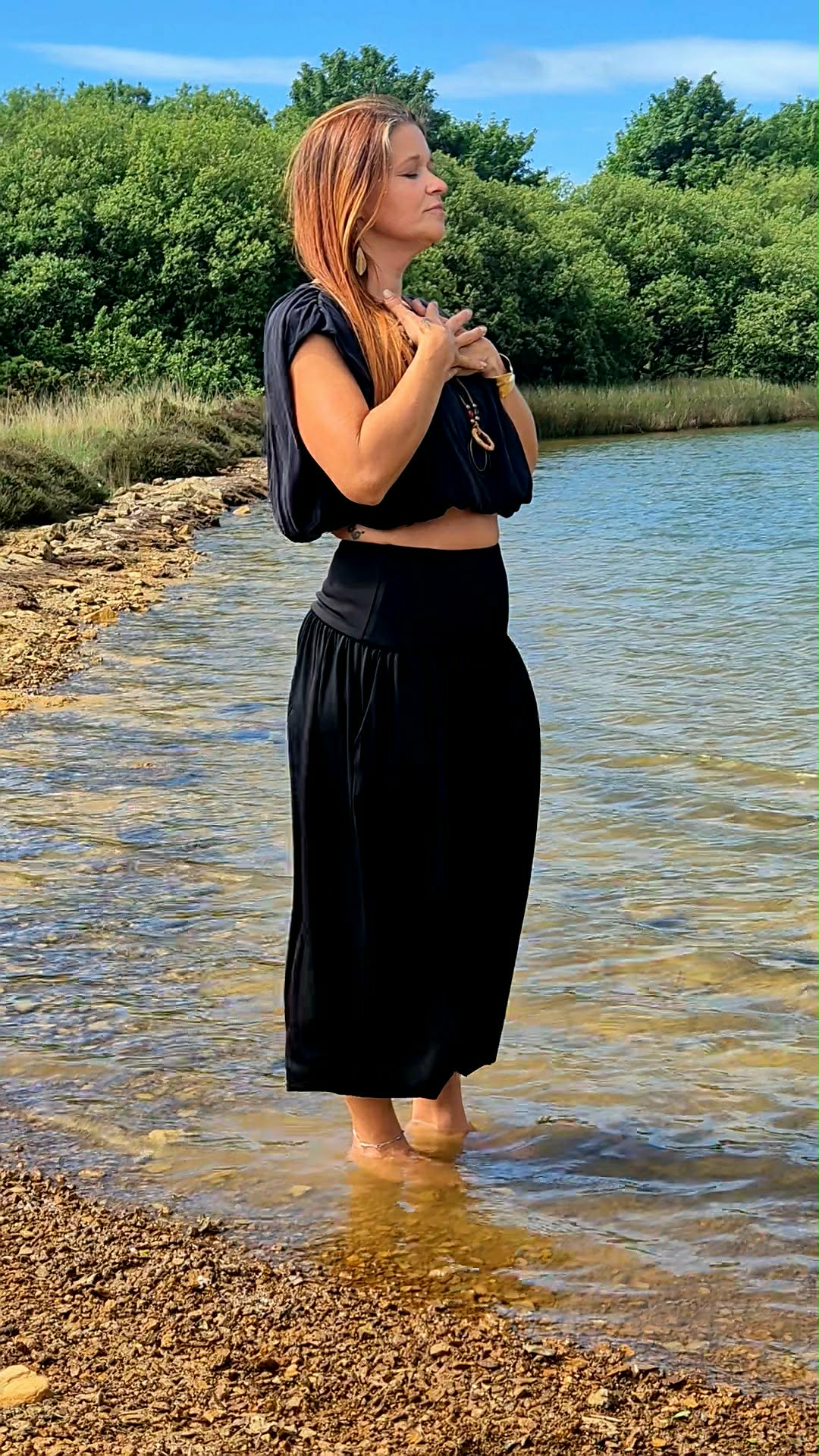 Tilly standing in water on the Isle of Anglesey